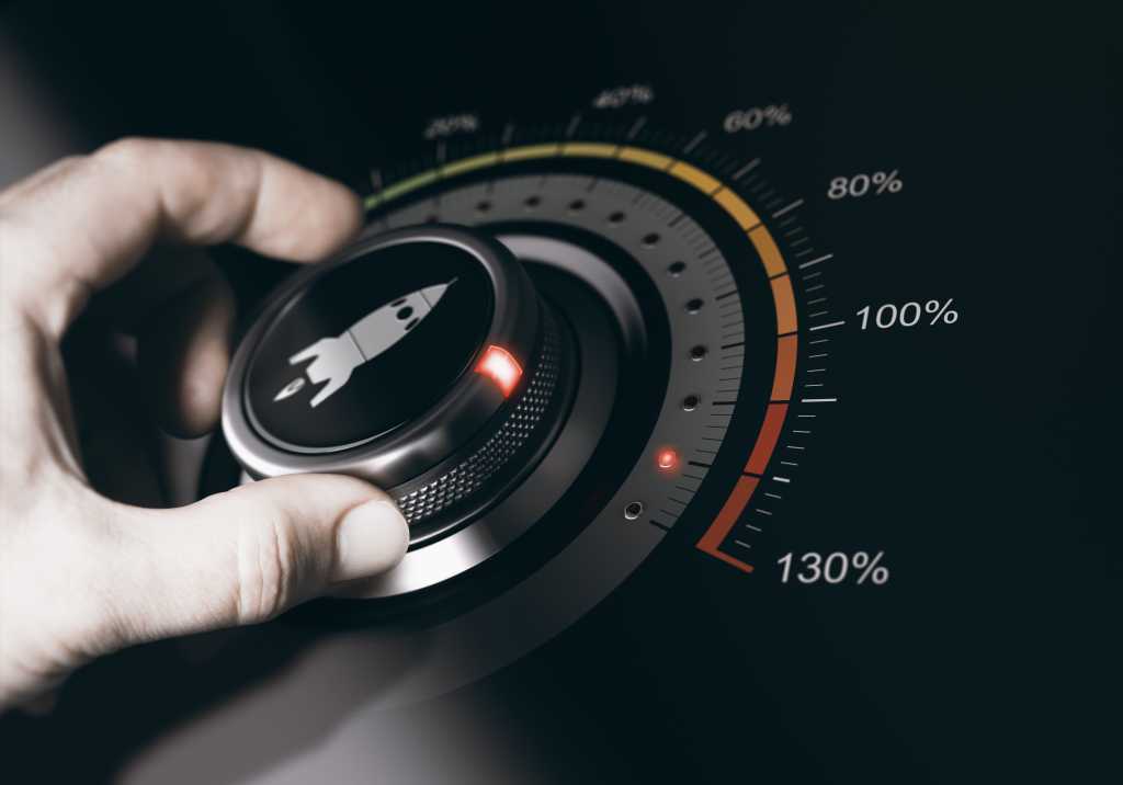 Hand turning a button with a rocket icon to the maximum acceleration. Concept of career acceleration. Composite between an image and a 3D background.